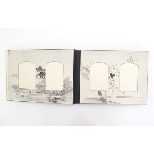 1054 - A Japanese photograph album with lacquered boards, the cover decorated with figures travelling by ha... 