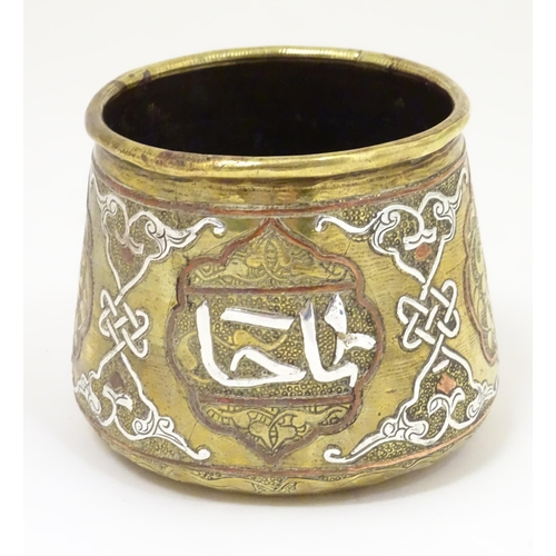 1055 - An early 20thC Middle Eastern brass pot of tapered form with engraved detail and inlaid white metal ... 