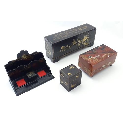 1057 - Four Oriental lacquered items comprising a desk tidy / organiser with shaped back decorated with a w... 