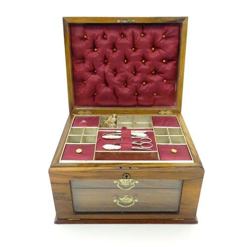 1061 - An early 20thC walnut vanity case / sewing box with fitted lift out tray to interior above two drawe... 