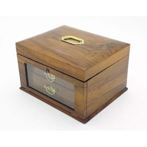 1061 - An early 20thC walnut vanity case / sewing box with fitted lift out tray to interior above two drawe... 