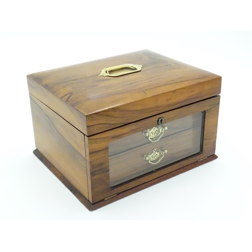 1061 - An early 20thC walnut vanity case / sewing box with fitted lift out tray to interior above two drawe... 