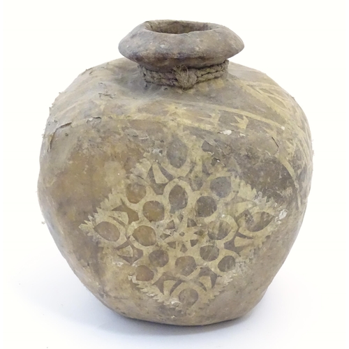 1082 - A leather / hide vase / vessel with applied geometric detail. Possibly Indian / Nepalese. Approx. 7