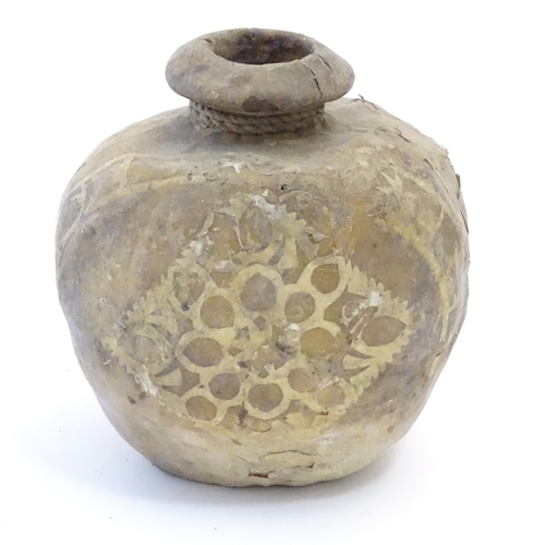 1082 - A leather / hide vase / vessel with applied geometric detail. Possibly Indian / Nepalese. Approx. 7