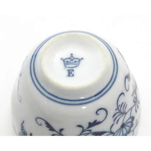 1108 - A late 19thC Continental blue and white ceramic tea bowl with floral and foliate decoration. The int... 