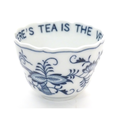 1108 - A late 19thC Continental blue and white ceramic tea bowl with floral and foliate decoration. The int... 