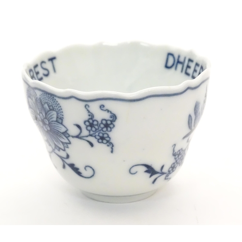 1108 - A late 19thC Continental blue and white ceramic tea bowl with floral and foliate decoration. The int... 