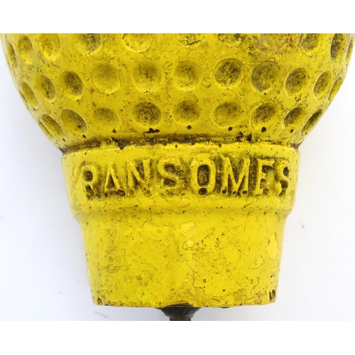 1119 - A 20thC novelty golf ball and tee advertising Ransomes - agricultural machinery makers. Approx. 10