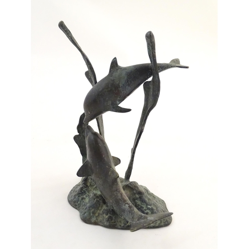 1122 - A 20thC cast bronze sculpture modelled as two dolphins swimming. Approx. 7 1/2