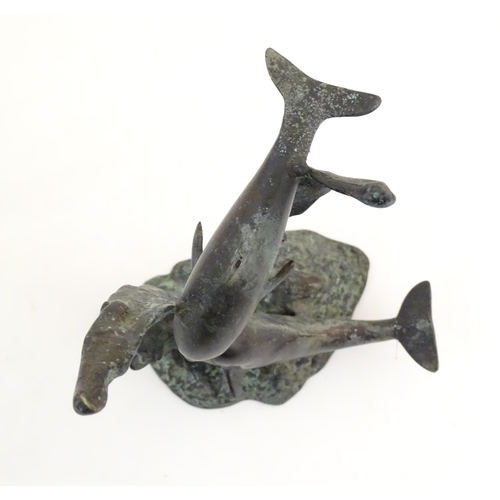 1122 - A 20thC cast bronze sculpture modelled as two dolphins swimming. Approx. 7 1/2