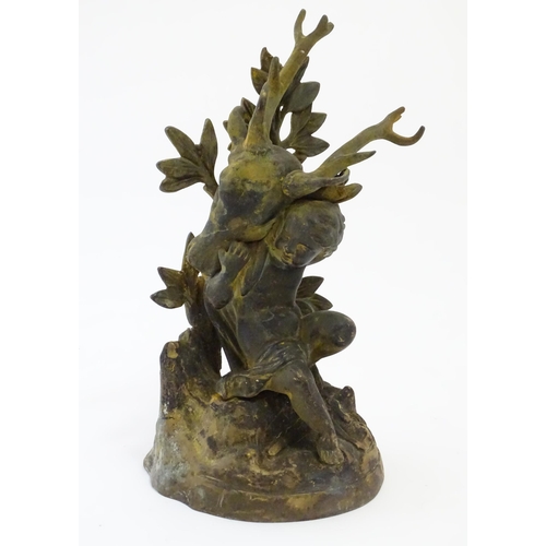 1123 - A 19thC cast brass model of a cherub / putto carrying a stag / deer head. Approx. 8 3/4