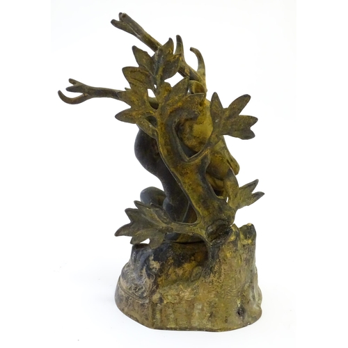 1123 - A 19thC cast brass model of a cherub / putto carrying a stag / deer head. Approx. 8 3/4