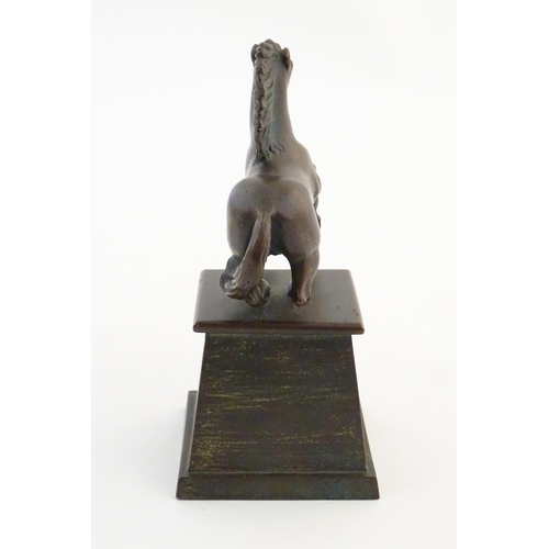 1124 - An early 20thC cast model of a rearing horse, on a tapered plinth base. Approx. 5 3/4