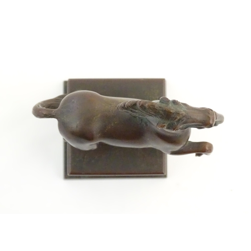 1124 - An early 20thC cast model of a rearing horse, on a tapered plinth base. Approx. 5 3/4