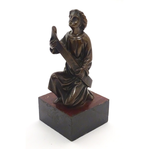 1126 - A 20thC cast bronze model of a classical figure kneeling with a large scroll. Approx. 7