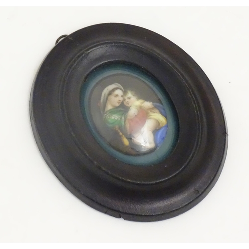 1140 - An early 20thC hand painted oval porcelain plaque depicting Madonna Della Sedia, mother and child, a... 