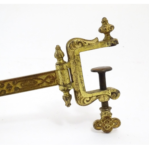 1178 - A late 19th / early 20thC cast and gilt fire screen bracket with clamp to one end. Approx. 10