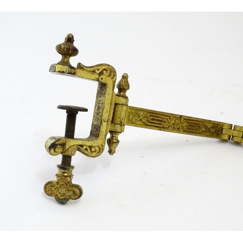 1178 - A late 19th / early 20thC cast and gilt fire screen bracket with clamp to one end. Approx. 10