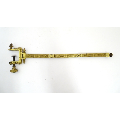 1178 - A late 19th / early 20thC cast and gilt fire screen bracket with clamp to one end. Approx. 10