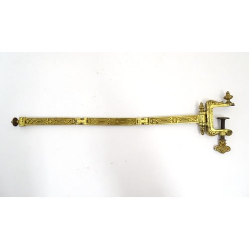 1178 - A late 19th / early 20thC cast and gilt fire screen bracket with clamp to one end. Approx. 10