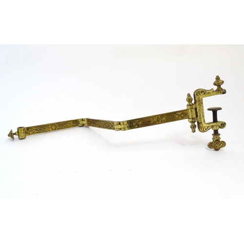 1178 - A late 19th / early 20thC cast and gilt fire screen bracket with clamp to one end. Approx. 10