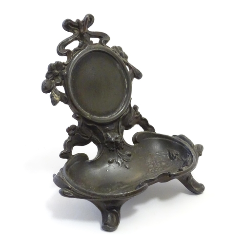 1186 - A late 19th / early 20thC cast pocket watch stand with crested ribboning, flowers and a shaped tray ... 