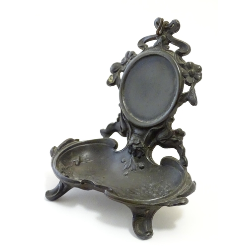 1186 - A late 19th / early 20thC cast pocket watch stand with crested ribboning, flowers and a shaped tray ... 