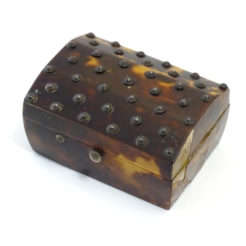 1197 - A 19thC miniature tortoiseshell box with stud detail to top. Approx. 1 1/4