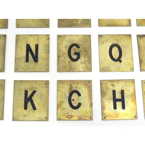 1215 - A quantity of 20thC brass plaques each with an enamel letter, comprising A, O, H, G, C, F, Q, E, L, ... 