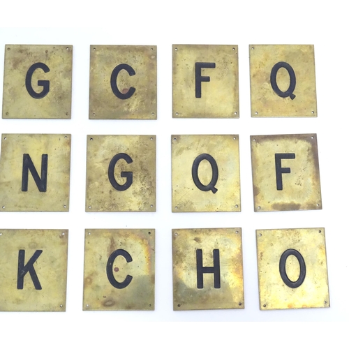 1215 - A quantity of 20thC brass plaques each with an enamel letter, comprising A, O, H, G, C, F, Q, E, L, ... 