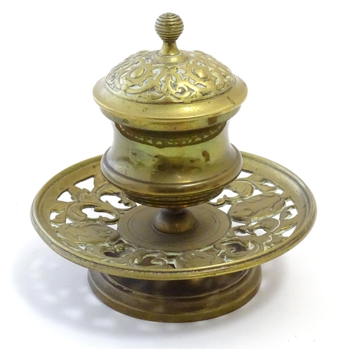 1216 - A Victorian cast brass desk inkwell of pedestal form with pierced foliate base. Approx. 4 3/4