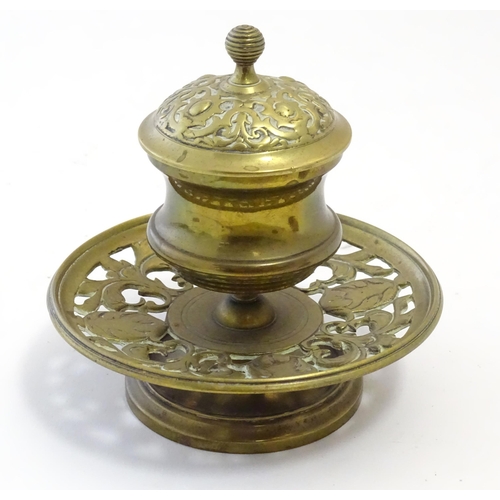 1216 - A Victorian cast brass desk inkwell of pedestal form with pierced foliate base. Approx. 4 3/4