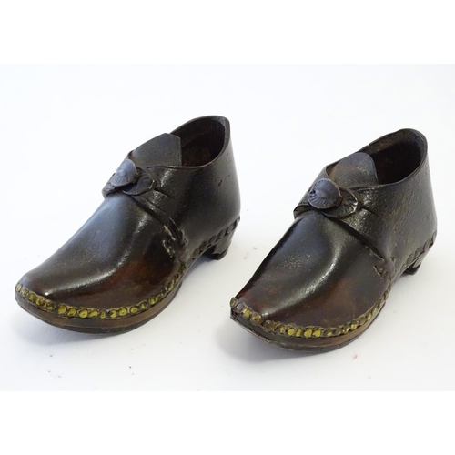 1219 - A pair of 19thC children's leather clogs with stud detail and wooden and metal soles. Approx. 2 1/2