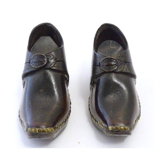 1219 - A pair of 19thC children's leather clogs with stud detail and wooden and metal soles. Approx. 2 1/2