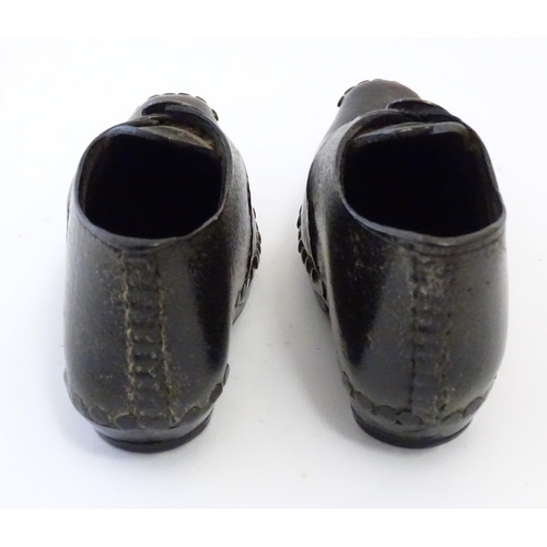 1219 - A pair of 19thC children's leather clogs with stud detail and wooden and metal soles. Approx. 2 1/2