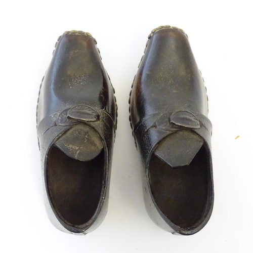 1219 - A pair of 19thC children's leather clogs with stud detail and wooden and metal soles. Approx. 2 1/2