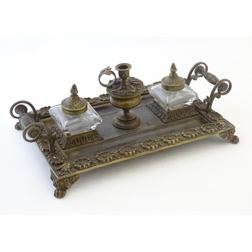 1253 - A Victorian cast brass standish / inkwell of rectangular form with twin scrolling handles and floral... 