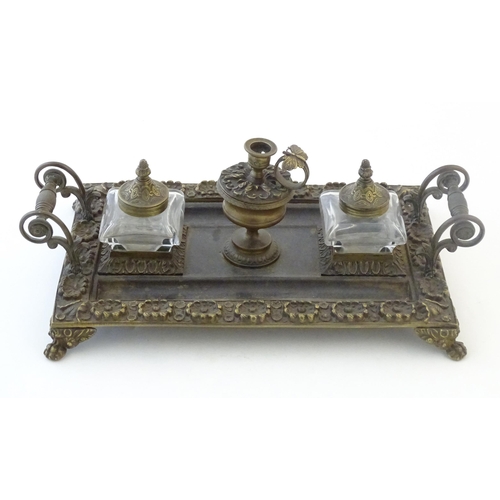 1253 - A Victorian cast brass standish / inkwell of rectangular form with twin scrolling handles and floral... 