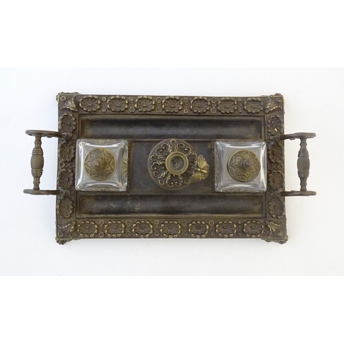 1253 - A Victorian cast brass standish / inkwell of rectangular form with twin scrolling handles and floral... 