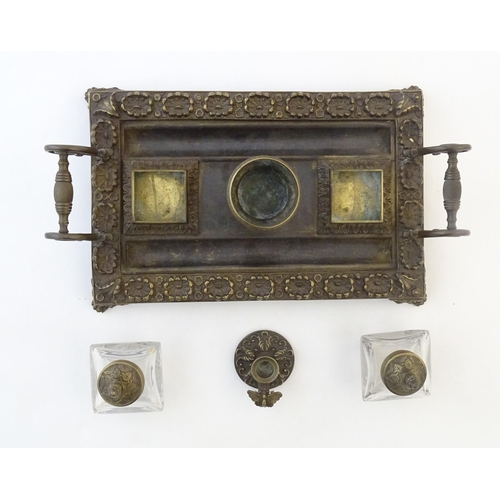 1253 - A Victorian cast brass standish / inkwell of rectangular form with twin scrolling handles and floral... 