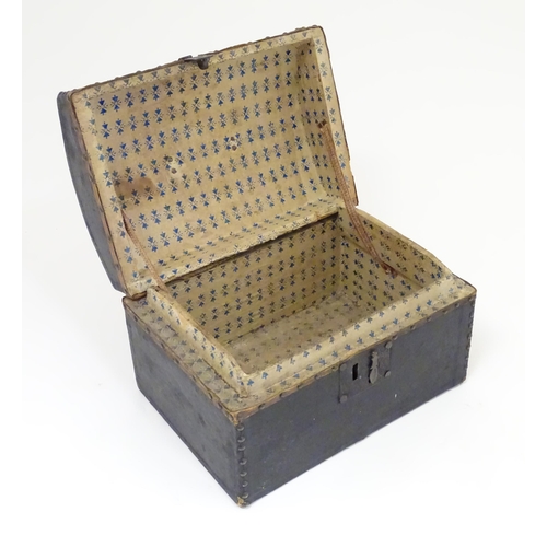 1254 - A 19thC leather covered casket / box with stud detail. Approx. 6 3/4