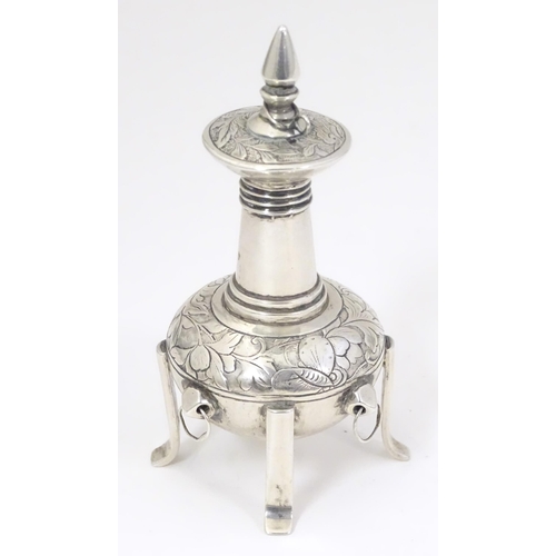 518 - A white metal scent bottle with engraved decoration formed as a stylised pagoda building on four fee... 