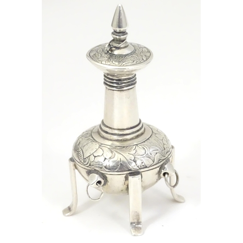 518 - A white metal scent bottle with engraved decoration formed as a stylised pagoda building on four fee... 