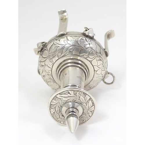 518 - A white metal scent bottle with engraved decoration formed as a stylised pagoda building on four fee... 