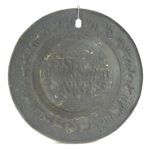 1273 - A large 20thC Indian brass charger with embossed decoration depicting an Indian procession with Impe... 