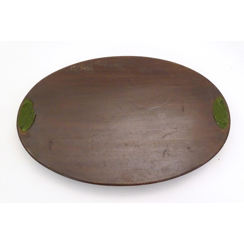 1284 - A late 19th / early 20thC mahogany tray of oval form with twin handles and central floral and foliat... 