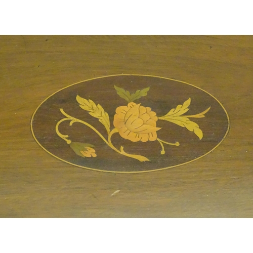 1284 - A late 19th / early 20thC mahogany tray of oval form with twin handles and central floral and foliat... 