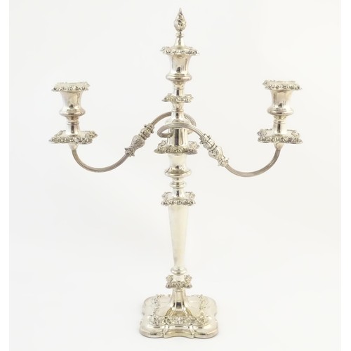 556A - A silver plate table candelabra with two scrolling branches and acanthus scroll detail. Approx 21