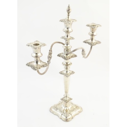 556A - A silver plate table candelabra with two scrolling branches and acanthus scroll detail. Approx 21