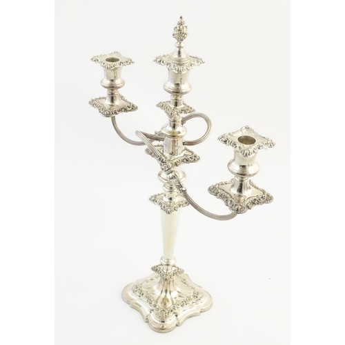 556A - A silver plate table candelabra with two scrolling branches and acanthus scroll detail. Approx 21